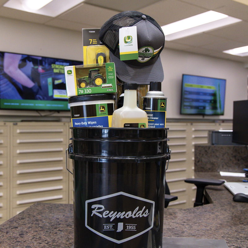 Reynolds bucket filled with parts, cleaners, apparel, toys and shop supplies