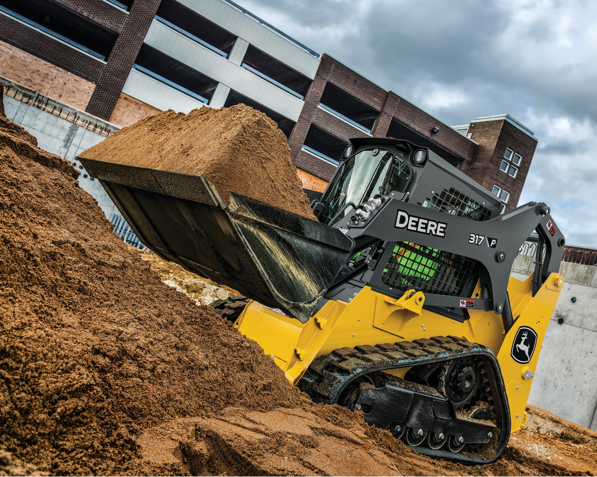 John Deere 317 P compact track loader moving material at a construction site